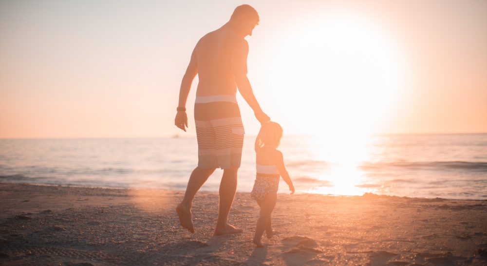 A man and small child on a beach in the Algarve