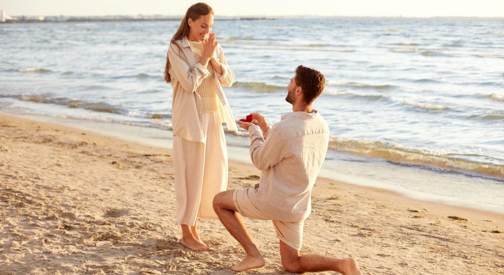 beach front proposal, man on one knee