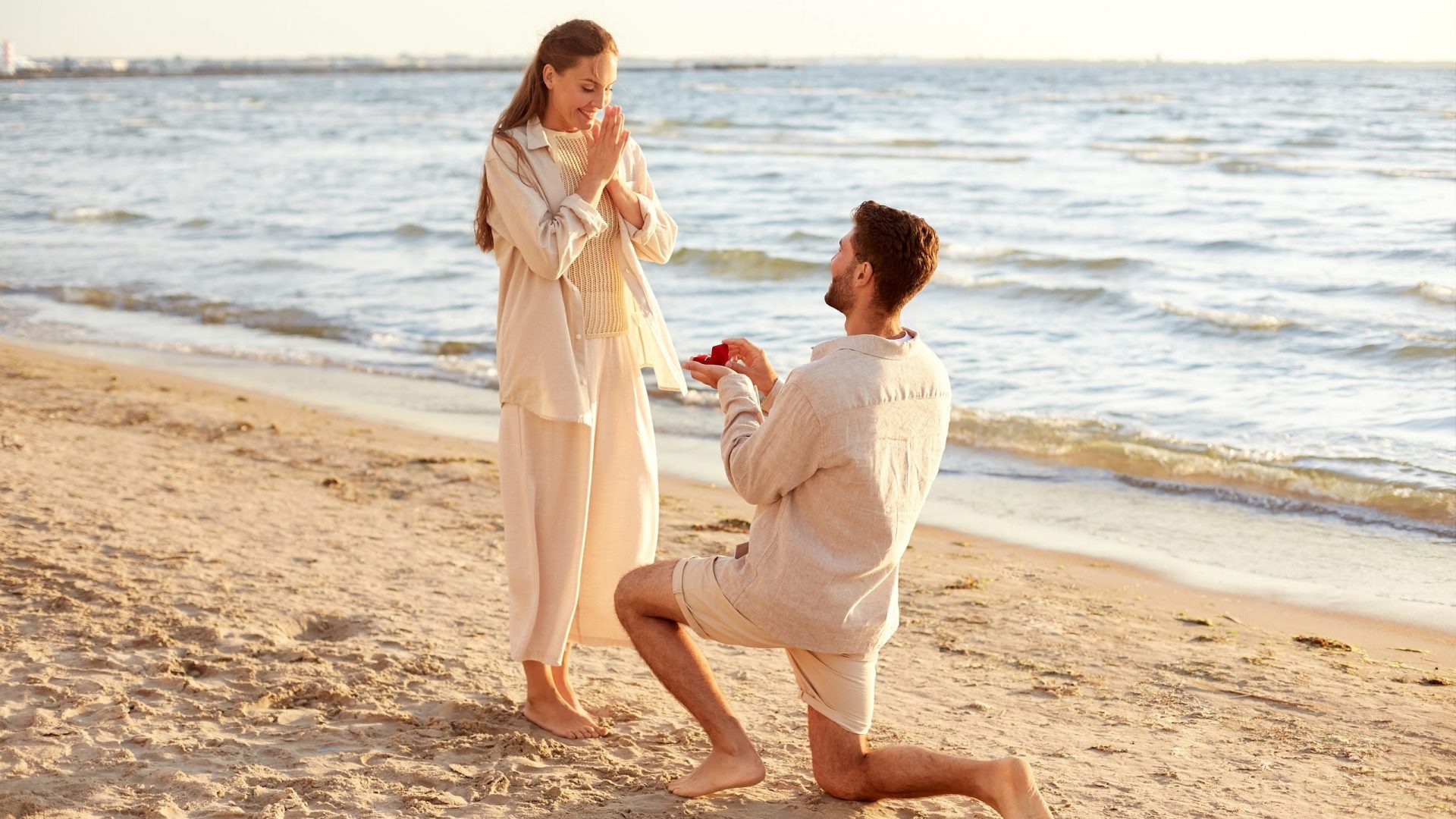 beach front proposal, man on one knee