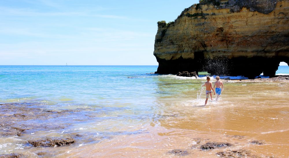 Kids playing on a beach in the Algarve